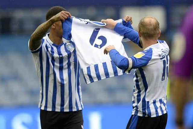 Home fans show their respect to former Owl Jose Semedo who lost his wife last week. Players Liam Palmer and Barry Bannan hold up a No 6 shirt after Wednesday's equalising goal   Picture: Steve Ellis