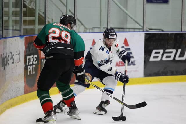 Sheffield Steeldogs James Spurr battles with Basingstoke's Alex Sampford during Sunday's 4-3 NIHL National Autumn Cup defeat. Picture courtesy of Peter Best