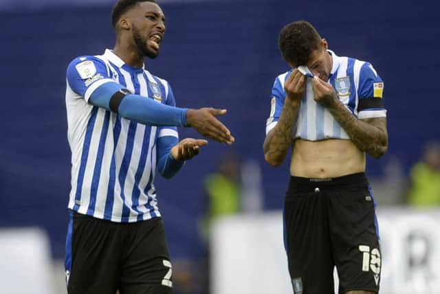 LATE DEFEAT: Sheffield Wednesday defenders Chey Dunkley and Marvin Johnson show their frustration at the final whistle. Picture: Steve Ellis.