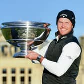 Danny Willett poses with the trophy on the Swilken Bridge after he wins the Alfred Dunhill Links Championship at St Andrews. Picture: PA.