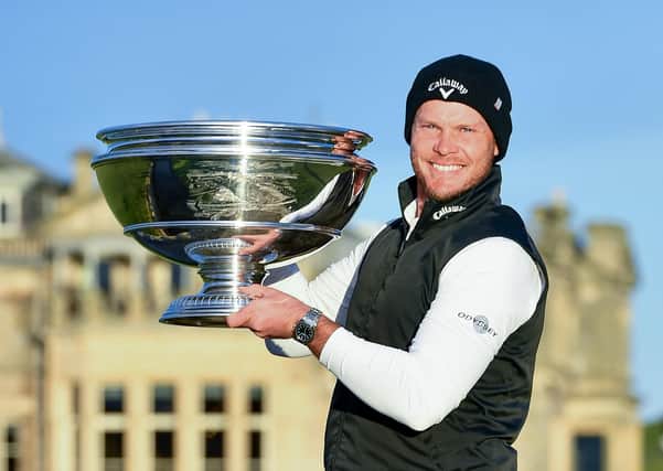Danny Willett poses with the trophy on the Swilken Bridge after he wins the Alfred Dunhill Links Championship at St Andrews. Picture: PA.