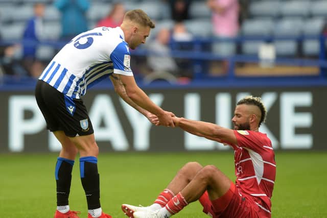 Doncaster Rovers' John Bostock gets a helping hand from Lewis Wing after being on the losing side at Sheffield Wednesday.  Picture: Steve Ellis