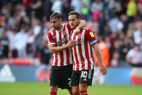 STAY POSITIVE: George Baldock hugs Sheffield United team-mate Billy Sharp after the recent win against Derby County at Bramall Lane Picture: Simon Bellis/Sportimage