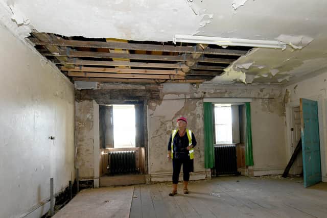 Julie Readman Facilities Manager at Wentworth Woodhouse in one of the Bedlam rooms that was like a swimming pool with flood water, when they first gained access to the building. Writer: Byline: Gary Longbottom