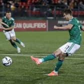 Northern Ireland's Paddy McNair scores his side's fourth goal during the World Cup 2022 Group C qualifying soccer match against Lithuania. (AP Photo/Mindaugas Kulbis).