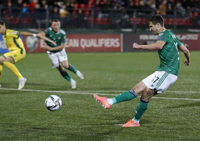 Northern Ireland's Paddy McNair scores his side's fourth goal during the World Cup 2022 Group C qualifying soccer match against Lithuania. (AP Photo/Mindaugas Kulbis).