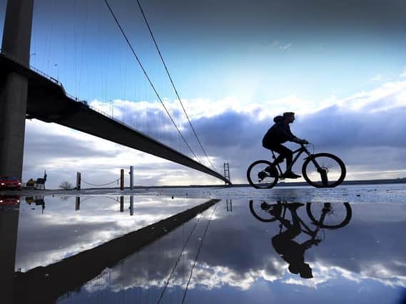 A cyclist riding past the Humber Bridge. (Pic credit: Simon Hulme)