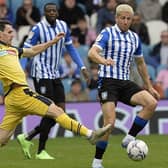 BLONDE AMBITION: Sheffield Wednesday midfielder Sam Hutchinson tackles former Owl Kieran Lee during his side's 1-0 win