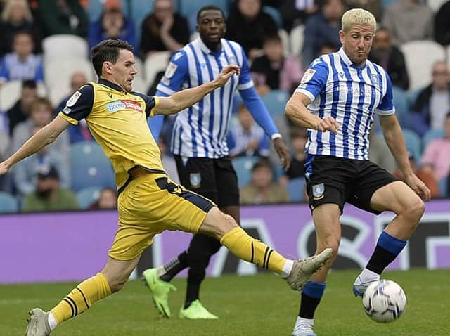 BLONDE AMBITION: Sheffield Wednesday midfielder Sam Hutchinson tackles former Owl Kieran Lee during his side's 1-0 win