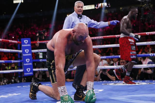 DOWN, BUT NOT OUT: Tyson Fury gets to his knees after being knocked down by Deontay Wilder in Las Vegas Picture: AP/Chase Stevens
