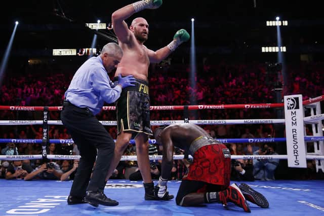 OVER AND OUT? Tyson Fury knocks down Deontay Wilder in Las Vegas Picture: AP/Chase Stevens