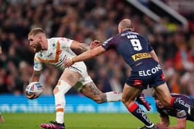 INJURY ISSUES: Catalans Dragons' Sam Tomkins (left) is tackled by St Helens' James Roby at Old Trafford Picture: Zac Goodwin/PA