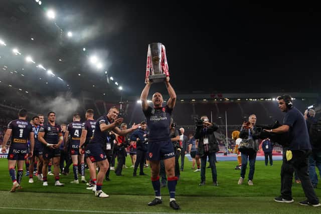 St Helens' James Roby lifts the Betfred Super League grand final trophy at Old Trafford Picture: Martin Rickett/PA