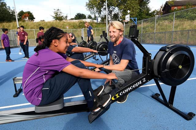 Three-time Olympic rowing champion Andy Triggs Hodge teaches Ellta Michael, aged 12, how to row at Dixons Trinity Chapeltown School in Leeds. Picture: Simon Hulme