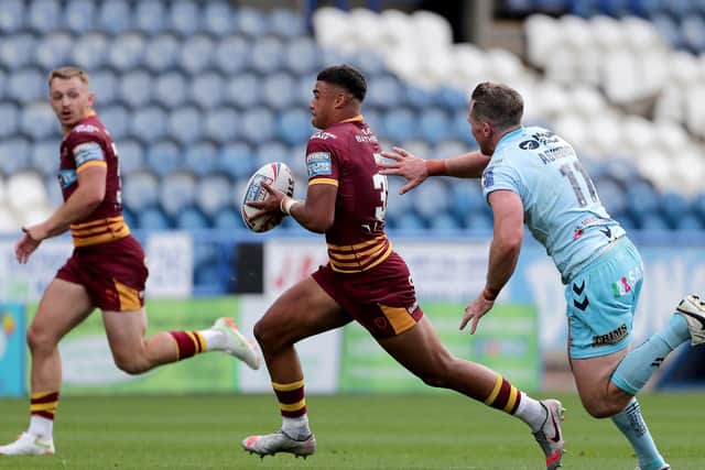 Huddersfield Giants' Will Pryce gets away from Wakefield Trinity's Matty Ashurst. Picture: PA.