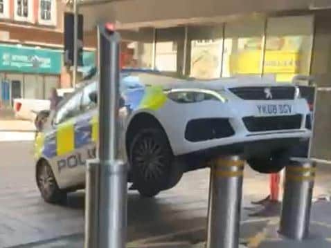The police car was stranded due to the automatic bollards rising