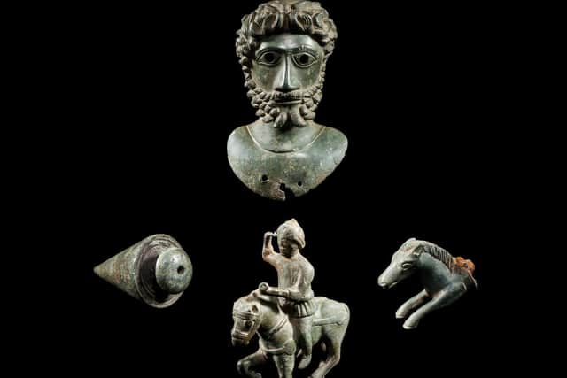 (clockwise from top) a bust of Marcus Aurelius, a handle of a knife shaped as part of a horse, a statuette of Mars, the Roman God of war, and a plumb bob used for engineering projects, all pieces from the Ryedale Bronzes.