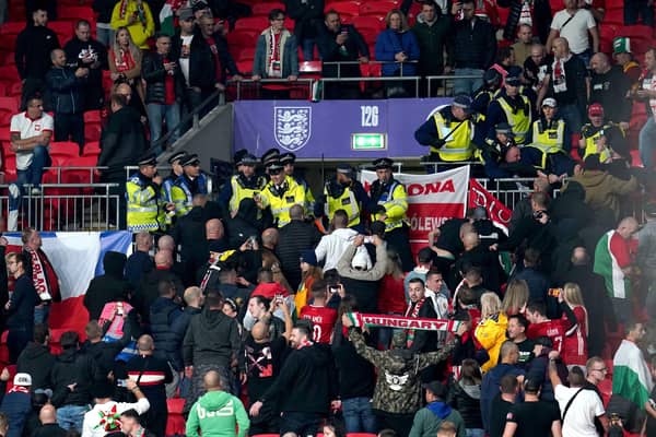 Hungary fans clash with police officers in the stands during the FIFA World Cup Qualifying match at Wembley. (Picture: PA)