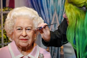Emma Meehan puts the finishing touches to a wax figure of Queen Elizabeth II at Madame Tussauds in Blackpool