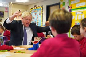 Prime Minister Boris Johnson interacts with school children during a visit to Westbury-On-Trym Church of England Academy in Bristol, prior to a regional cabinet meeting in the city yesterday.