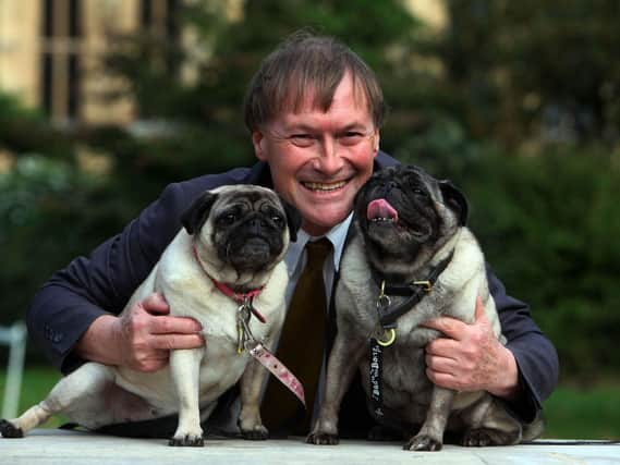 File photo dated 10/10/13 of Conservative MP David Amess with his pugs, Lily and Boat at the Westminster Dog of the Year competition at Victoria Tower Gardens in London (PA)