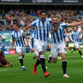 Huddersfield's Tom Lees celebrates opening the scoring with Levi Colwill. Picture: Jonathan Gawthorpe