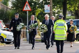 Chief Constable Ben-Julian Harrington, Labour Party leader Keir Starmer, Prime Minister Boris Johnson, Speaker of the House Sir Lindsay Hoyle and Home Secretary Priti Patel carry flowers as they arrive at the scene near Belfairs Methodist Church in Eastwood Road North, Leigh-on-Sea, Essex, where Conservative MP Sir David Amess died after he was stabbed several times at a constituency surgery on Friday.