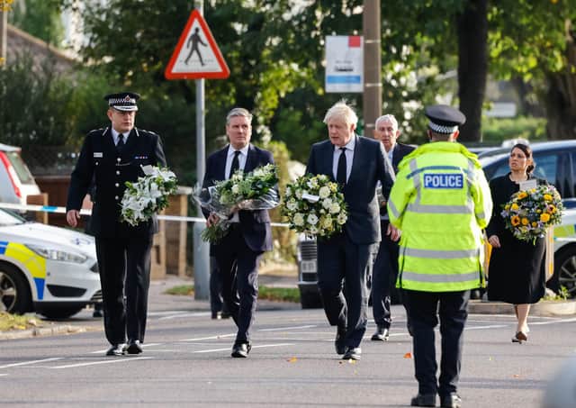 Chief Constable Ben-Julian Harrington, Labour Party leader Keir Starmer, Prime Minister Boris Johnson, Speaker of the House Sir Lindsay Hoyle and Home Secretary Priti Patel carry flowers as they arrive at the scene near Belfairs Methodist Church in Eastwood Road North, Leigh-on-Sea, Essex, where Conservative MP Sir David Amess died after he was stabbed several times at a constituency surgery on Friday.