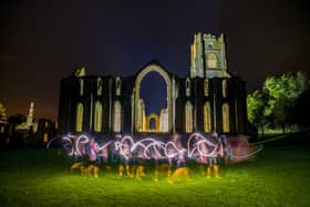 Hazel  Shepherd dances with a torch  at Fountains Abbey, illuminated  for the public to visit on weekend evenings throughout October. Picture Tony Johnson