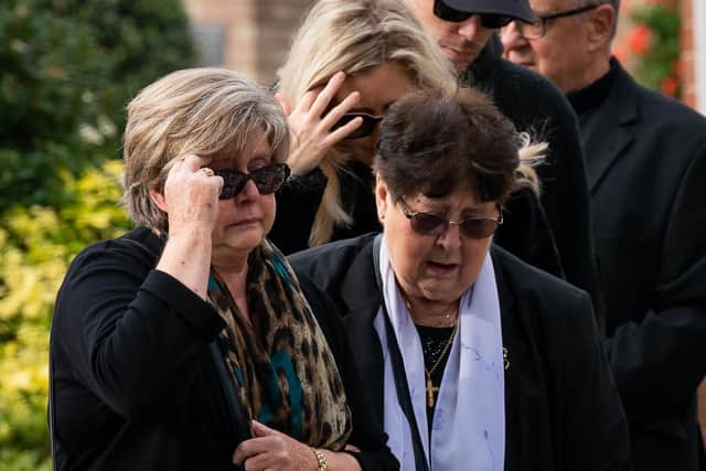Julia Amess (left) the widow of Conservative MP Sir David Amess, stands with friends and family members to view flowers and tributes left for her late husband at Belfairs Methodist Church