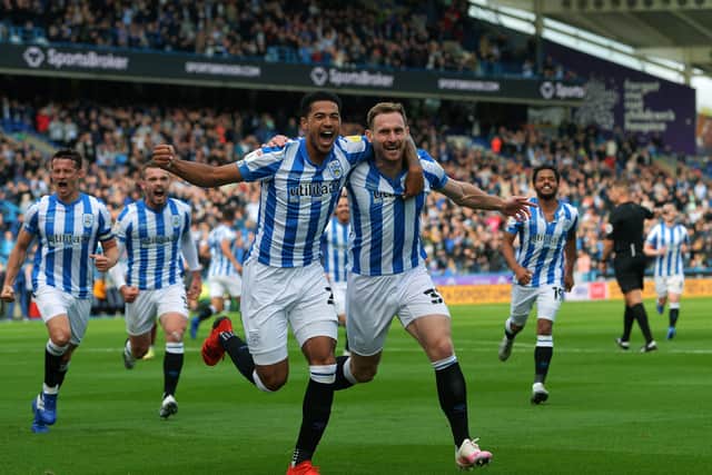 Huddersfield's Tom Lees celebrates opening the scoring against Hull with Levi Colwill.
 (Picture: Jonathan Gawthorpe)
