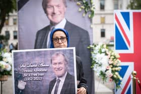 Members of the National Council of Resistance of Iran hold a vigil outside the Houses of Parliament in London in memory of Sir David Amess who was a supporter of their cause for a free Iran.