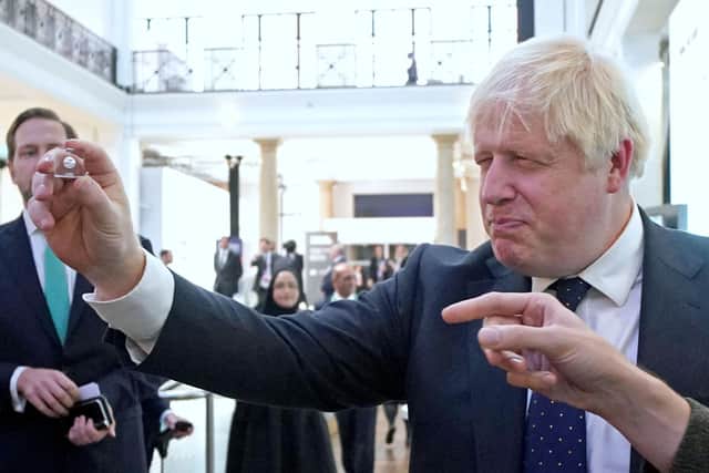 Prime Minister Boris Johnson looks at a product from the First Light Fusion stand during a visit to the Innovation Zone of the Global Investment Summit at the Science Museum, London.