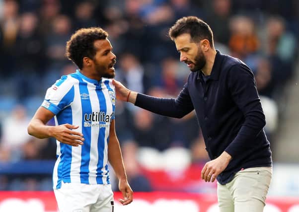 STAND BY YOUR MAN: Huddersfield Town manager Carlos Corberan (right) and midfielder Duane Holmes Picture: Tim Markland/PA
