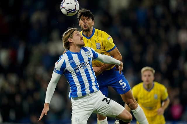 HARD-WORKING: Huddersfield Town's Danny Ward battles George Friend in the air