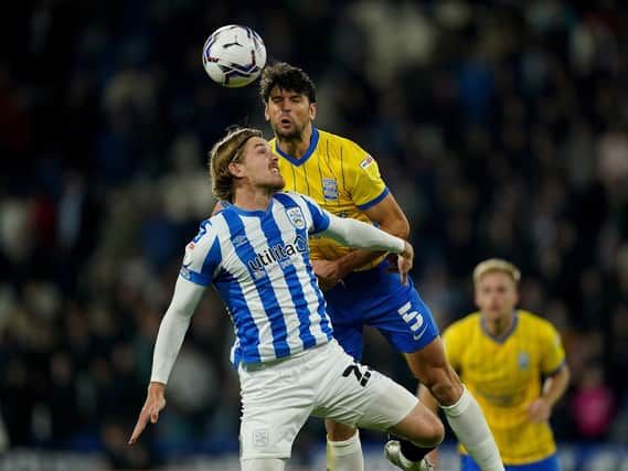 HARD-WORKING: Huddersfield Town's Danny Ward battles George Friend in the air