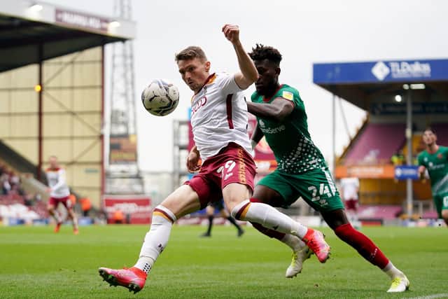 Bradford City's Caolan Lavery (left) and Walsall's Rollin Menayese battle for the ball. Picture: PA