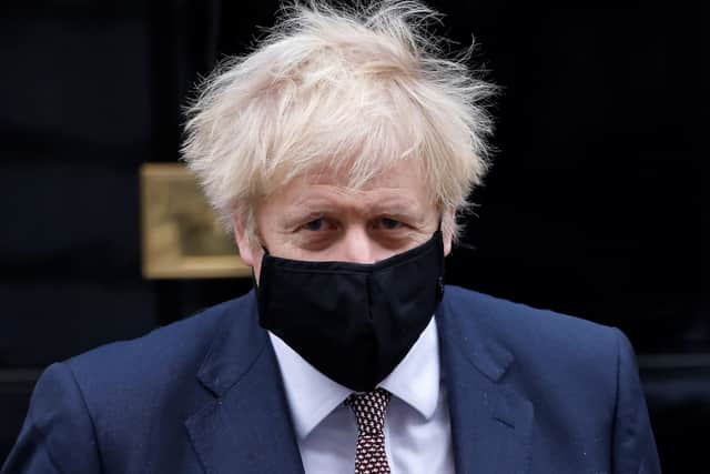 This was Boris Johnson wearing a face mask last year as he left Downing Street.