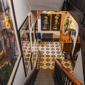 The hallway with the stair carpet from KD Carpets, tiles from Topps Tiles, and all the woodwork in matt black.