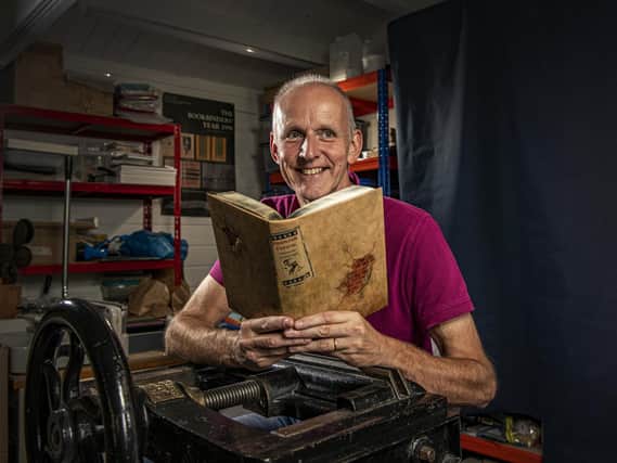 Glenn Malkin in his Hornsea workshop with one of his art bindings. (Tony Johnson).