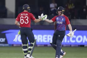 England's captain Eoin Morgan, right and teammate England's Jos Buttler shake hands and hug after they defeated West Indies during the Cricket T20 World Cup. (AP Photo/Aijaz Rahi)