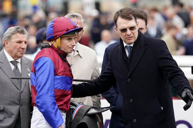 Trainer Aidan O'Brien talks with jockey Ryan Moore after winning the Vertem Futurity Trophy with Luxembourg.