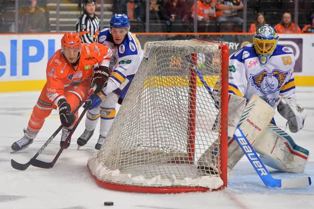 Jonathan Phillips battles for possession around the back of the Fife flyers net. Picture courtesy of Dean Woolley/EIHL.