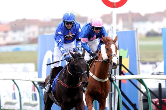 This was Mighty Thunder winning the 2021 Coral Scottish Grand National under Tom Scudamore.