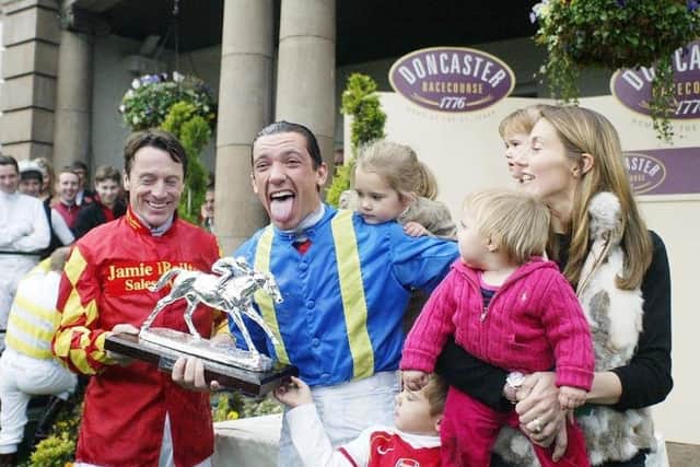 A seminol moment:  Frankie Dettori (centre) receives the Jockey Championship trophy from fellow jockey Kieren Fallon as his wife Catherine (right) and children look on, at Doncaster, Saturday November 6, 2004.
