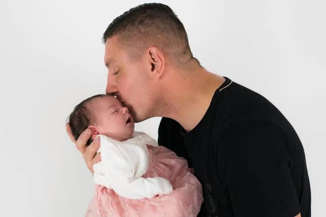 Alan Barefoot with his newborn daughter