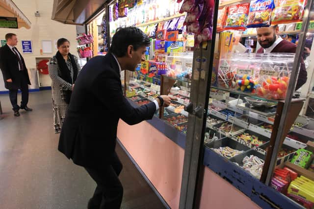 Rishi Sunak visiting a sweet stall at Bury Market on the morning after his Budget.