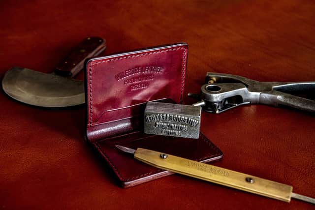 A leather wallet with the stamp he authenticates his work. (Tony Johnson).