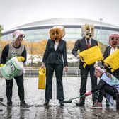Activists from Ocean Rebellion wearing oil heads with 75-litres of fake oil, in front of the Hydro, Glasgow, as the city prepares for the Cop26 conference. (PA)