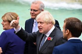 Prime Minister Boris Johnson gives a thumbs up as he stands with Chancellor of Germany, Angela Merkel Prime Minister of Australia, Scott Morrison and French President Emmanuel Macron as they join G20 leaders during a visit to the Trevi fountain in Rome (PA)